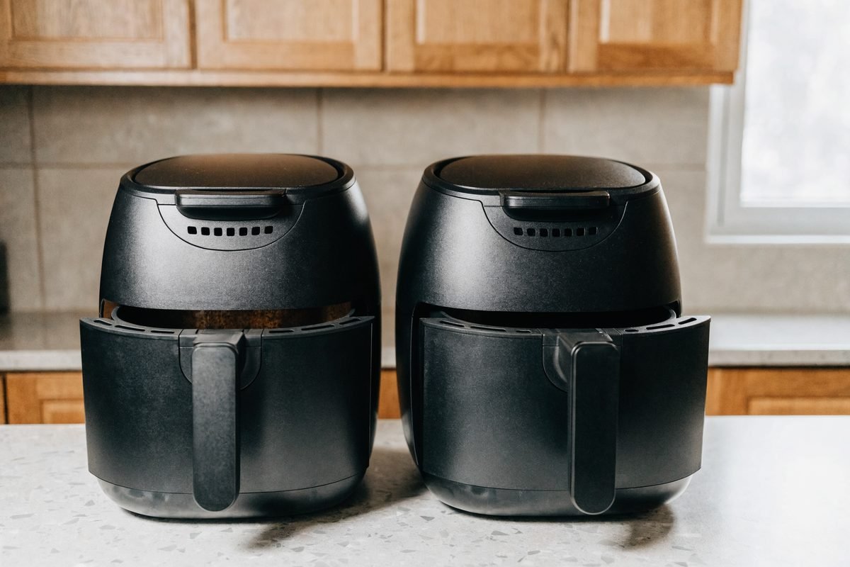 Duas air fryers lado a lado, uma com ferrugem visível no cesto